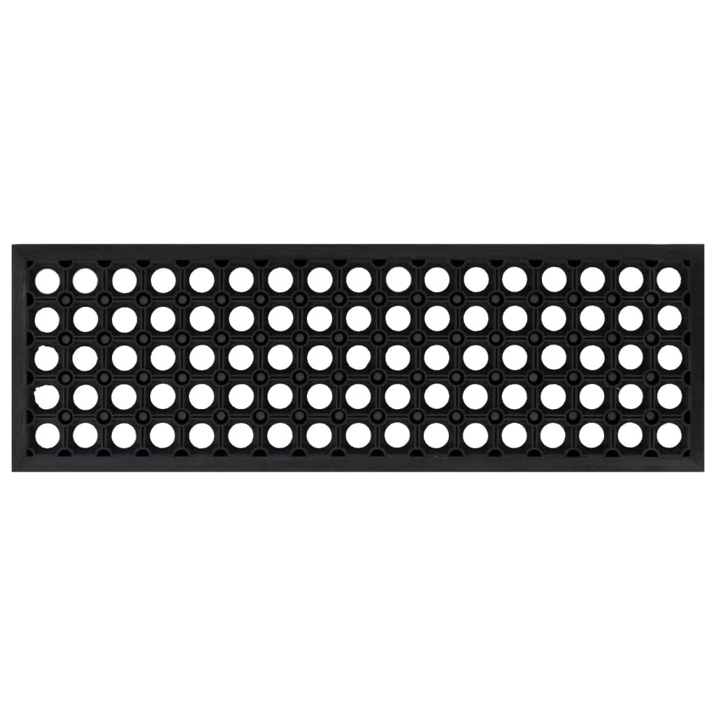 A single black rubber stair tread with a pattern of many small holes