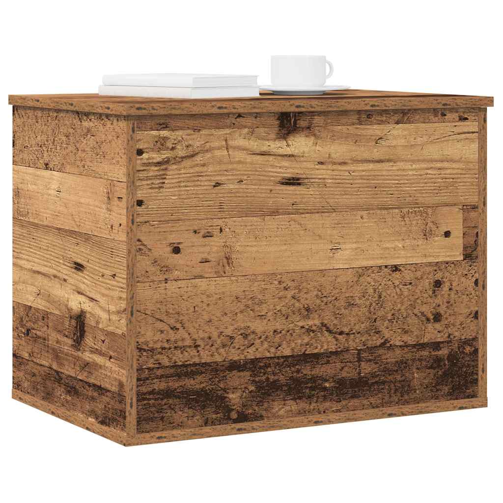 The storage chest used as a side table with books and a cup on top