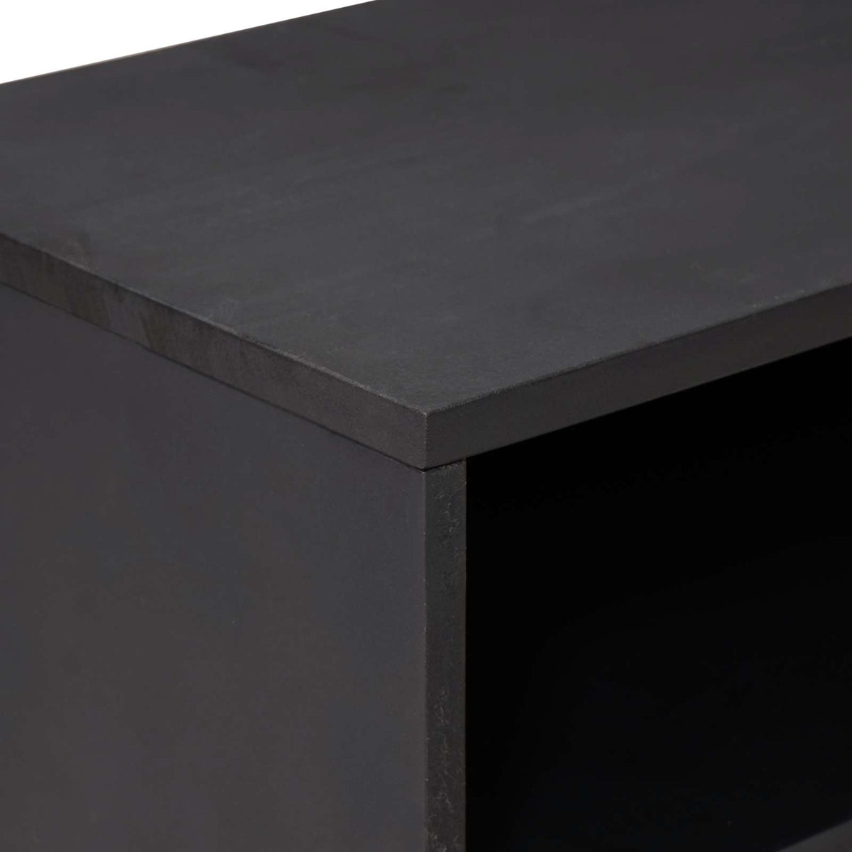 A close-up of the top corner of the media storage cabinet showing the smooth dark surface