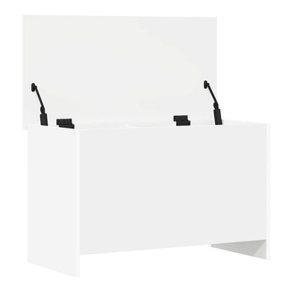 The white storage chest with lid open, showing hinges