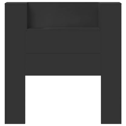 A close-up of the black engineered wood storage headboard