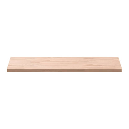 The rectangular solid wood beech table top shown from a low side angle