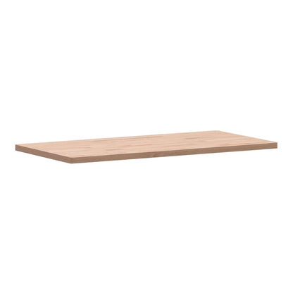 The rectangular solid wood beech table top shown from a side angle