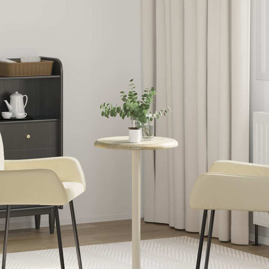 Table Top Cream Marble shown in a room setting with two chairs and a plant