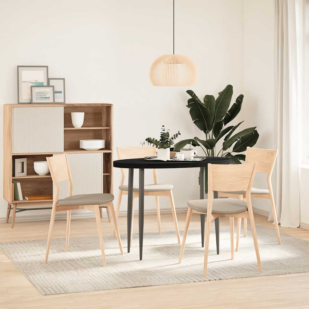 Oval dark brown solid wood oak table top used in a dining room setting