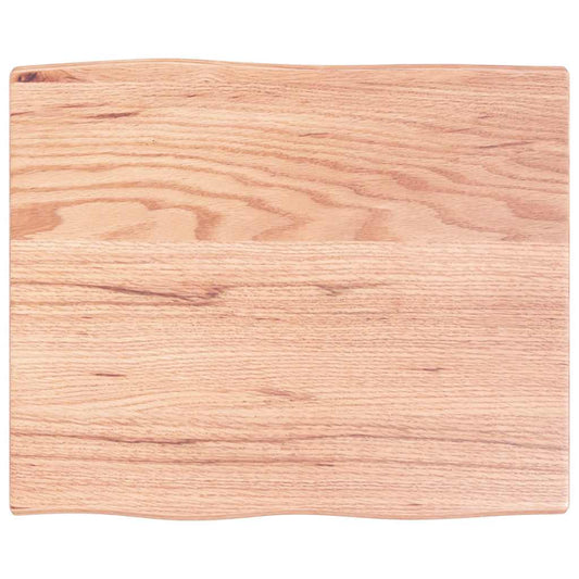Close up of the light brown solid wood oak live edge table top showing grain