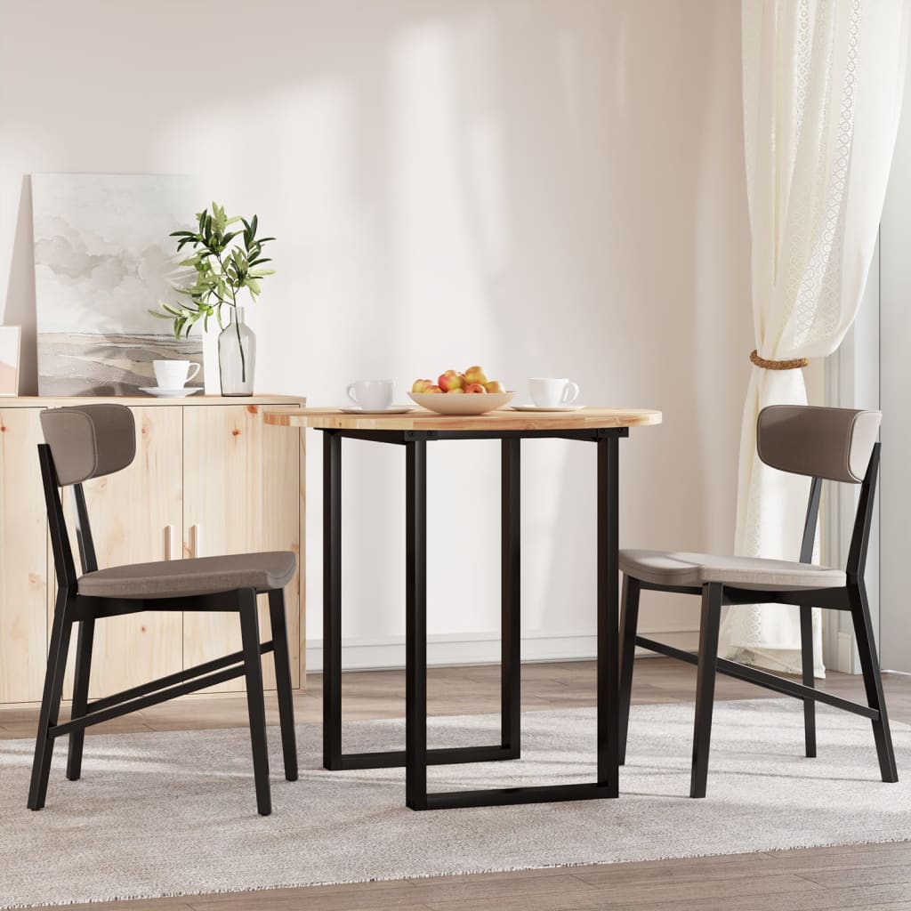 The round acacia wood table top is set up in a dining room with two chairs