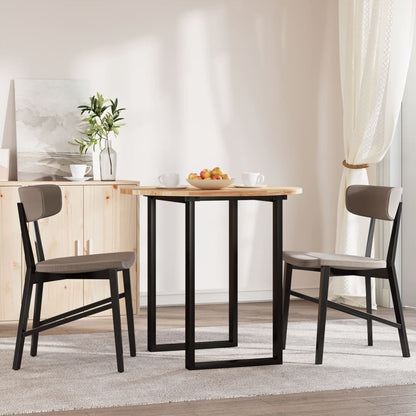 The round acacia wood table top is set up in a dining room with two chairs