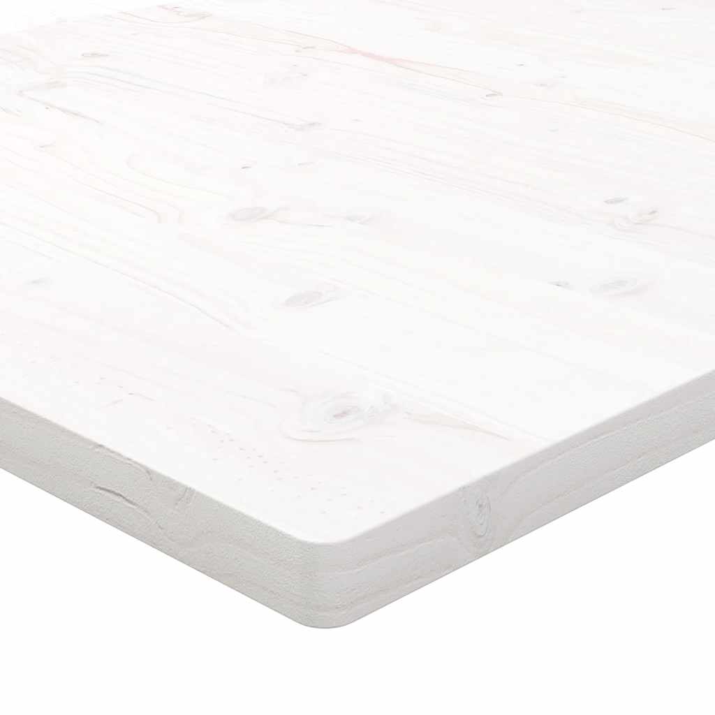 A close up of the corner of the table top showing the texture of the white wood
