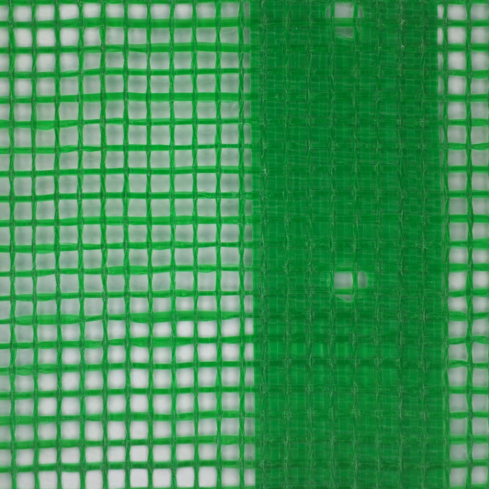 close up of the green tarpaulin showing its woven structure