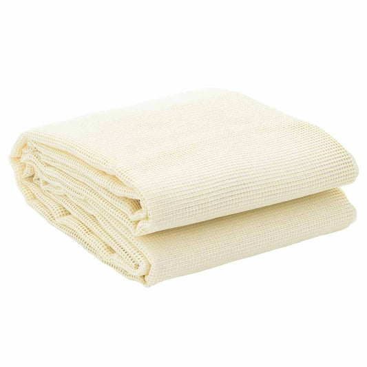 A cream coloured tent carpet folded neatly on top of itself