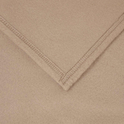 the fleece blanket showing a close-up of the stitched hem and fabric texture