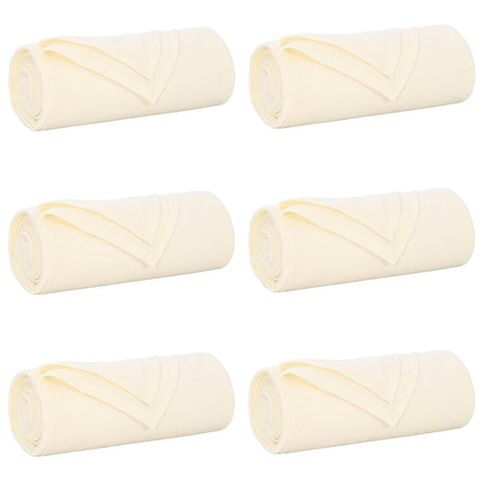 Six cream fleece blankets rolled up and placed side by side