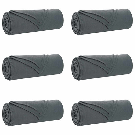 the grey blankets arranged in two rows of three rolled up items