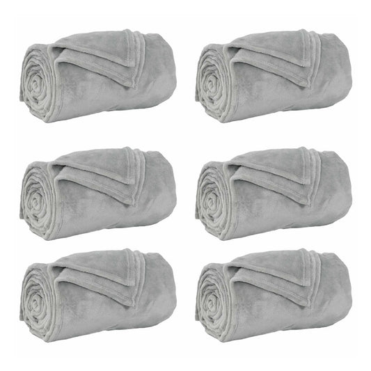 Six grey fleece blankets rolled up and placed side by side on a white background