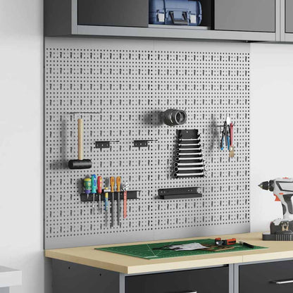 the grey steel tool storage panel mounted on a wall above a workbench