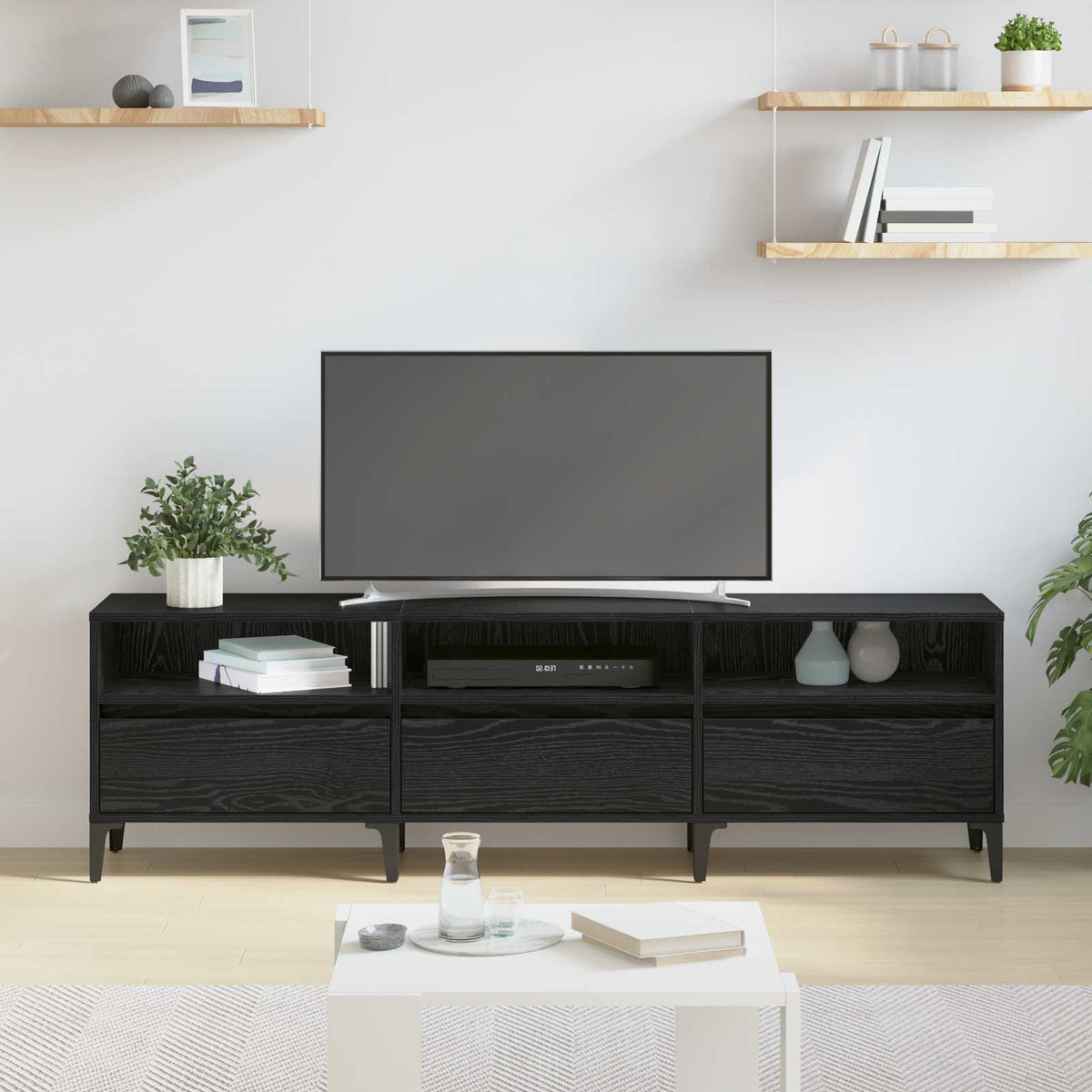 Black oak TV cabinet with a television and decorative items in a modern living room