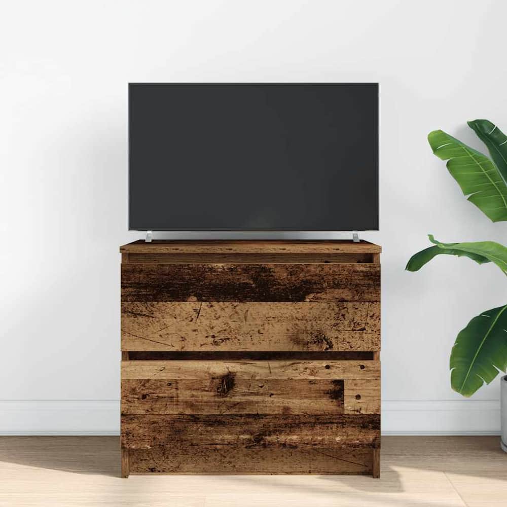 The rustic wood effect TV cabinet has a television on top and a plant beside it