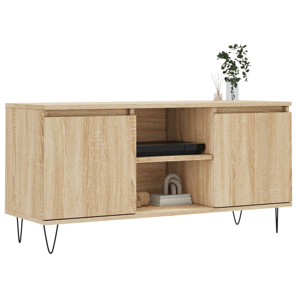 The TV cabinet with two closed doors and open shelving, styled with books and a plant