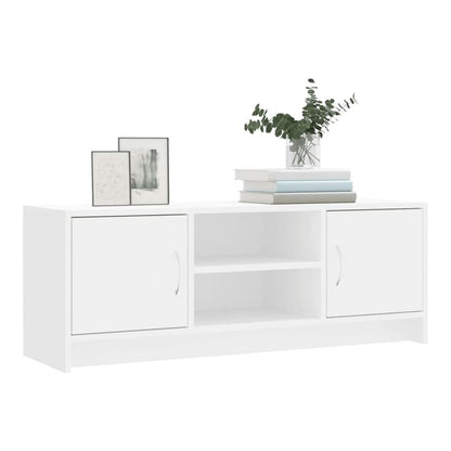 The white TV cabinet has two doors and a central shelf, with books and pictures on top