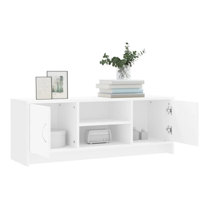 The white TV cabinet with doors open showing storage compartments and a central shelf