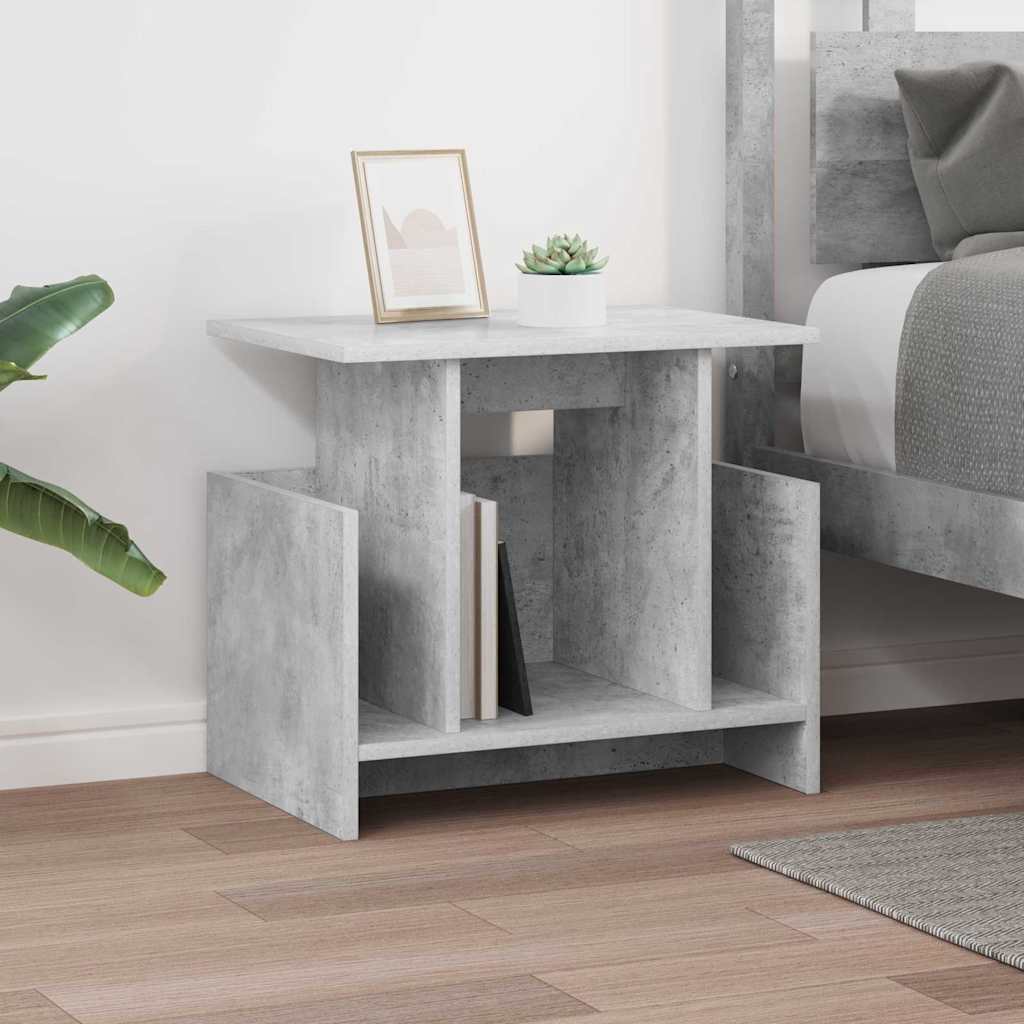 The TV stand positioned next to a bed with a small plant and frame on top