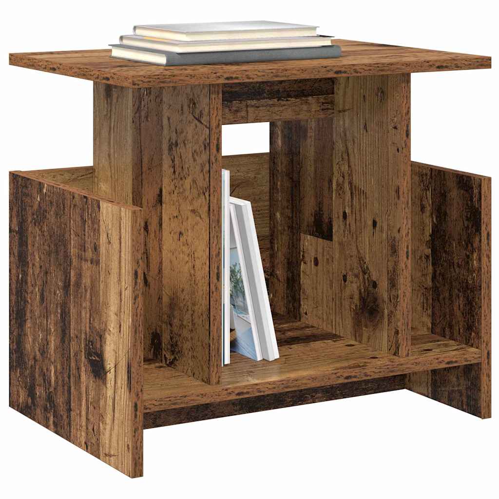 The TV stand featuring a flat top surface and an open storage shelf with books inside