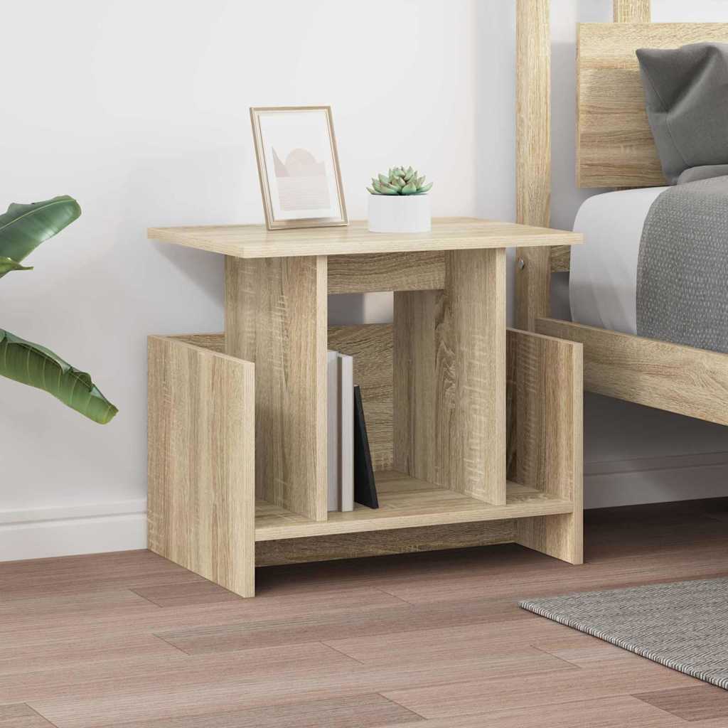 the TV stand styled as a nightstand next to a bed with a picture frame and plant