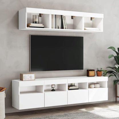 Several white wall cabinets mounted together above a television stand