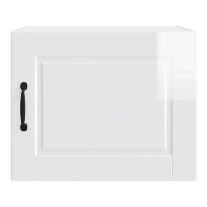 The front of the white wall cabinet with a black handle and a recessed panel