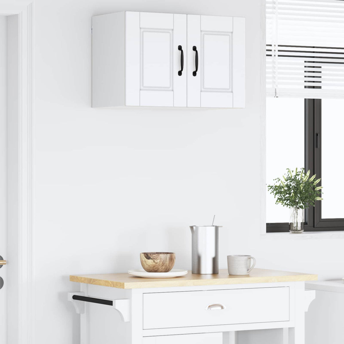 The white wall cabinet mounted on a wall above a kitchen counter, with a window in the background