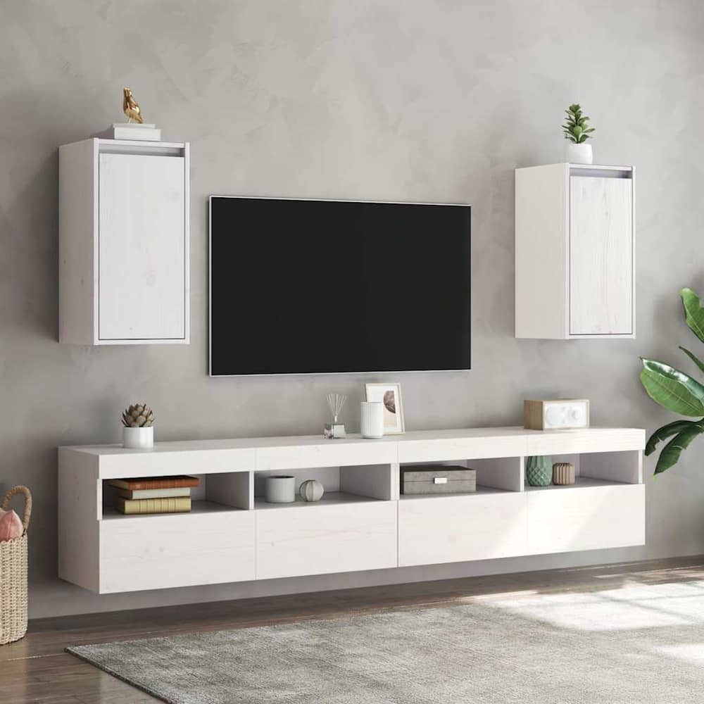 Two white wall cabinets mounted above a media console with a television