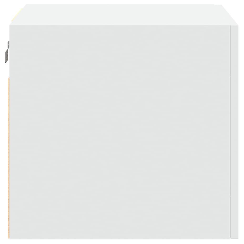 The white wall cabinet shown from the side, revealing the unfinished wood edge