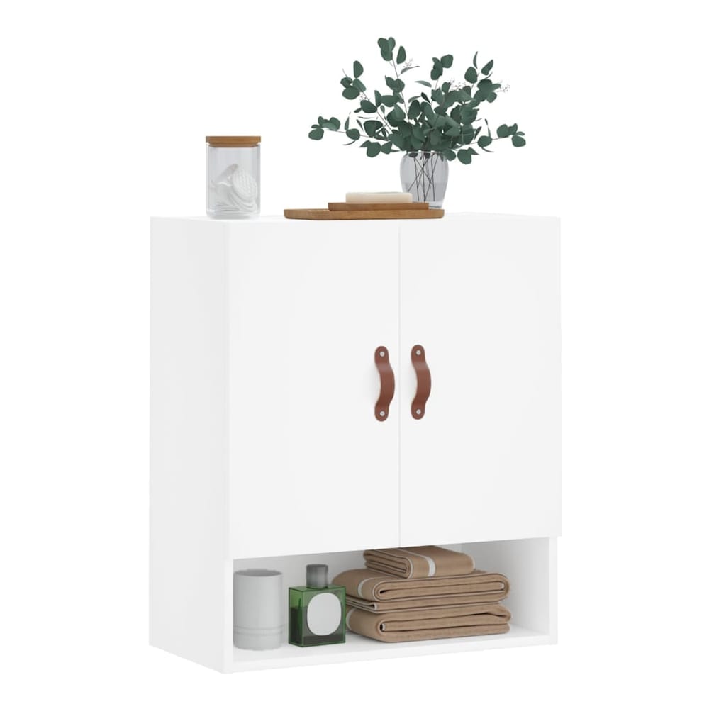 White wall cabinet with two brown leather handles and an open shelf below, styled with toiletries and towels