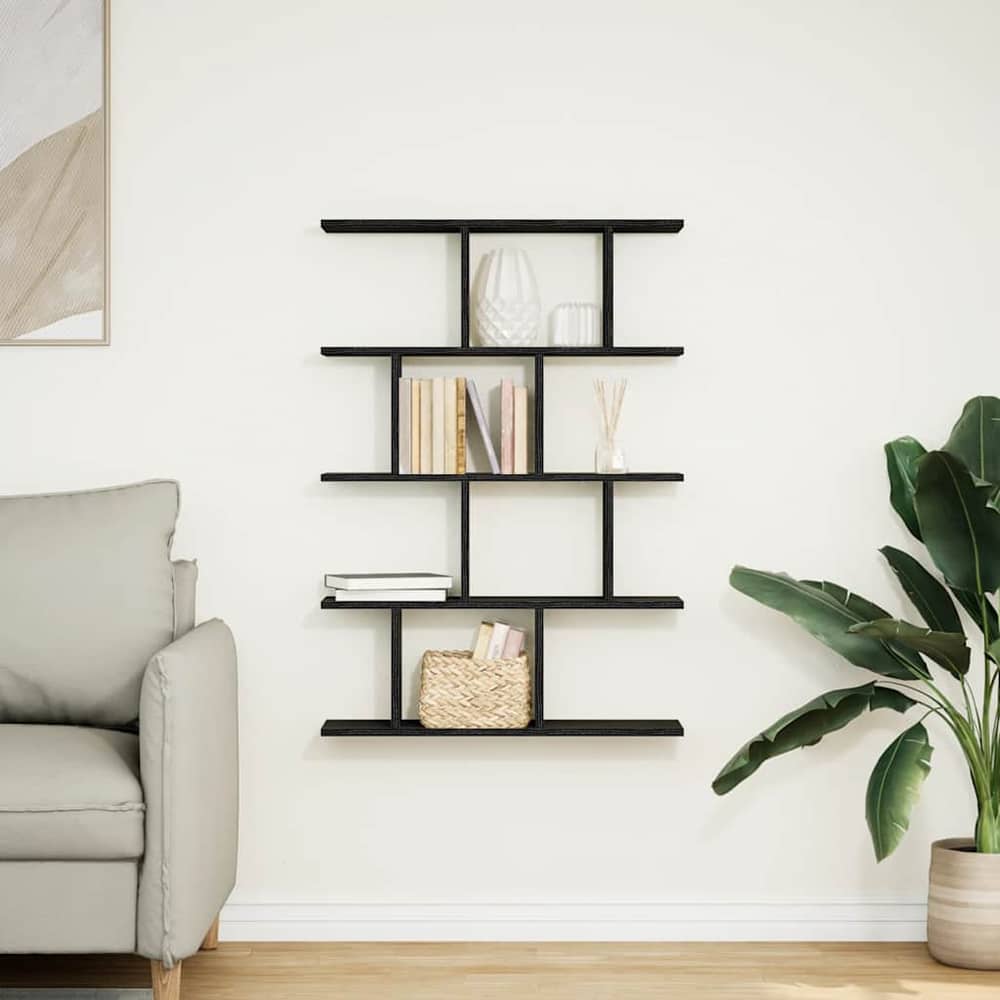 The wall cube shelf 12 compartments black engineered wood in a living room setting next to a sofa and plant