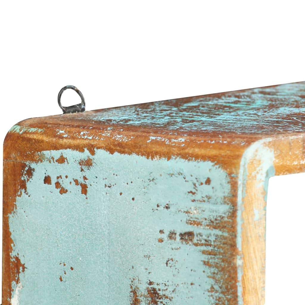 Close up of the distressed wood finish and hanging loop on a wall shelf