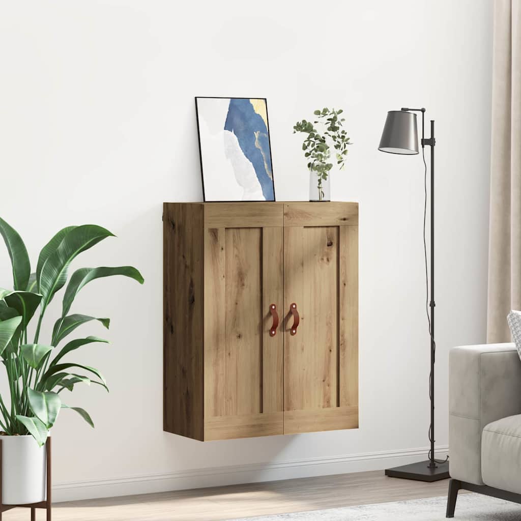 The wall cabinet mounted in a living room setting next to a floor lamp and a plant