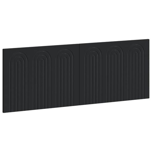 The black wall-mounted headboard has a repeating arched pattern across its surface