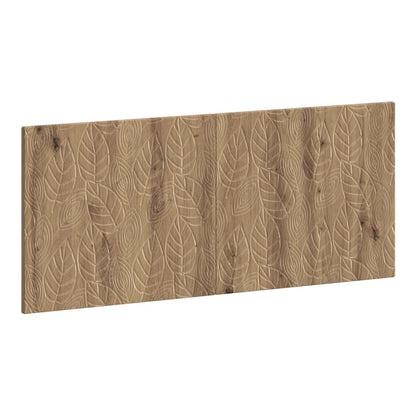 The wall-mounted headboard with a carved leaf pattern in artisan oak effect