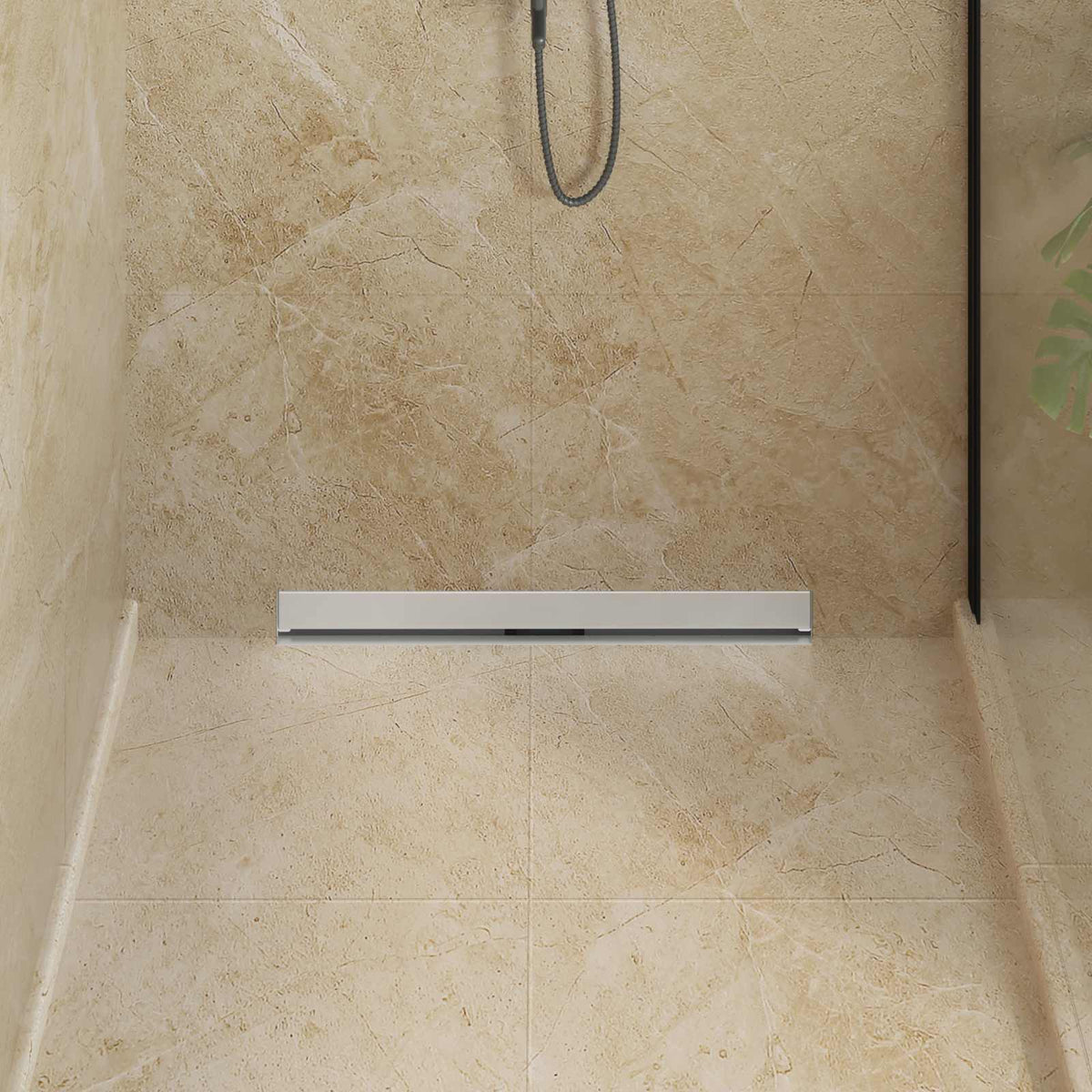 The wall mounted shower drain fitted at the base of a beige tiled shower wall