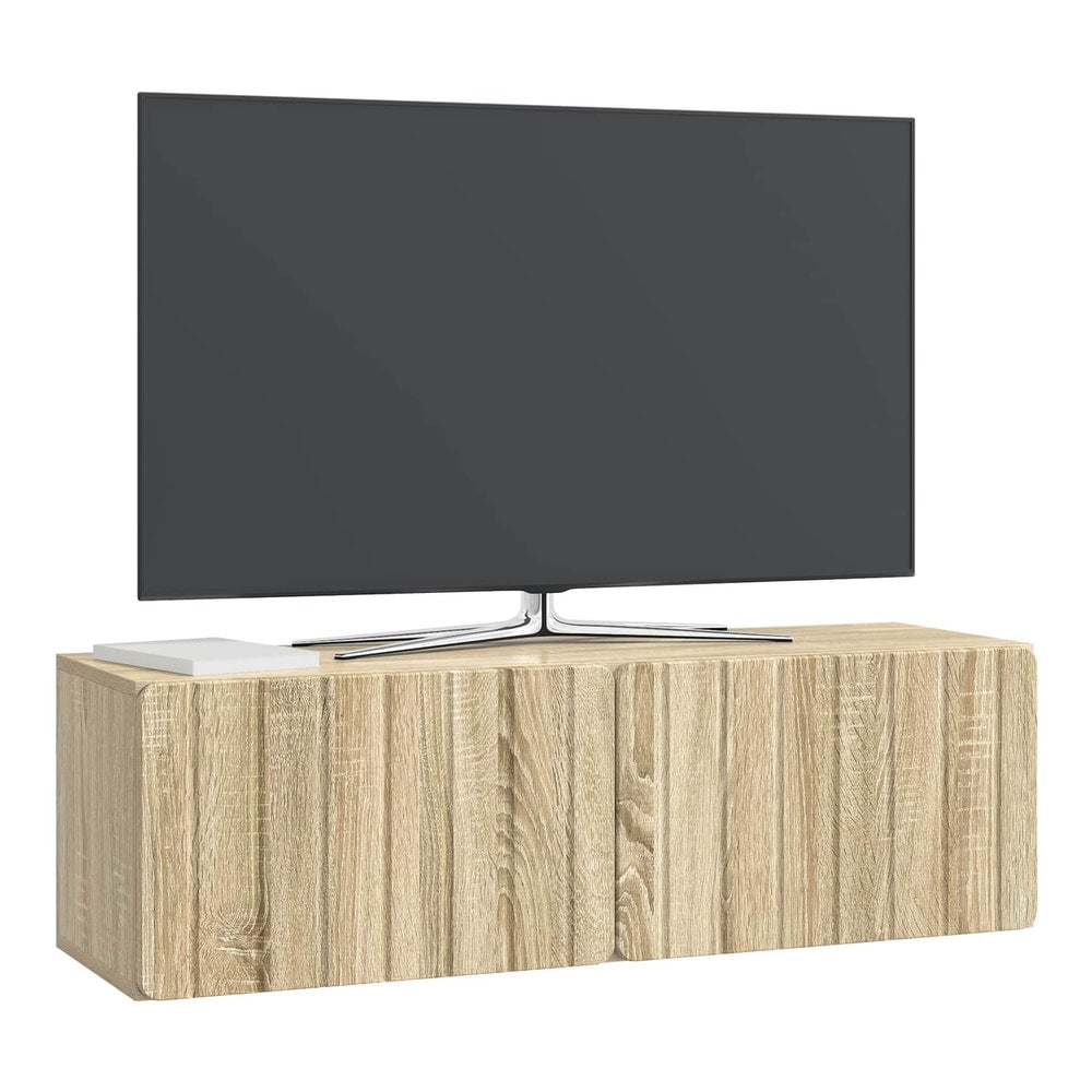 A wall-mounted TV cabinet with a TV placed on top, set against a plain wall