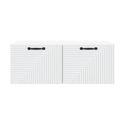 Close-up of the textured front panels and black handles of a white TV cabinet
