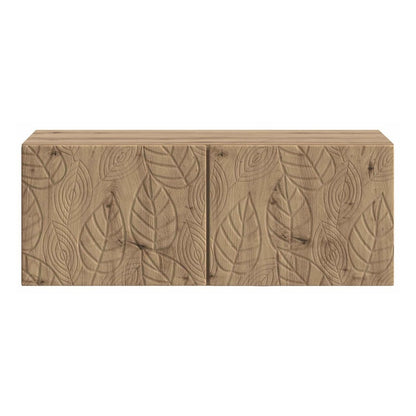 The TV cabinet showing the detailed leaf carvings on the two closed front doors