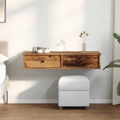 The wooden wall shelf with drawers mounted on a wall above a white ottoman