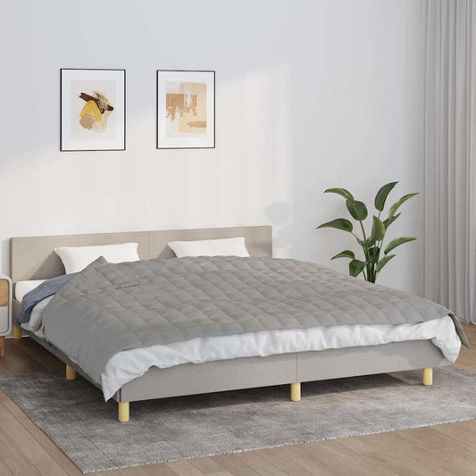 vidaXL Weighted Blanket Grey 7 kg laid out on a bed with pillows and a duvet