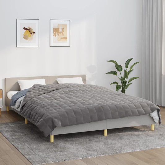 vidaXL Weighted Blanket Grey 15 kg laid out on a bed with two pillows and a plant in a room