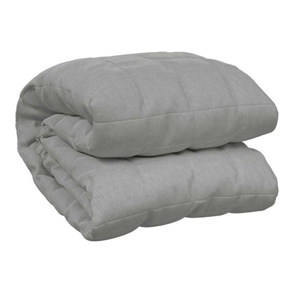 The grey weighted blanket folded neatly on a plain background