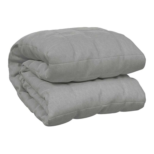 The grey weighted blanket folded neatly on a plain background