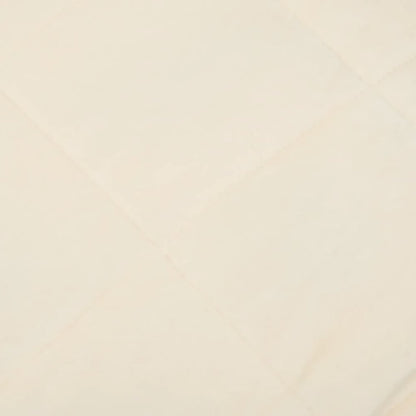 Close up of the light cream fabric of a blanket