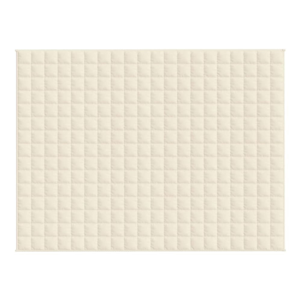 The quilted pattern of a light cream blanket